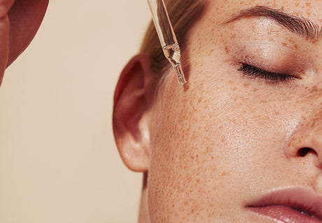 a girl putting skincare on her face