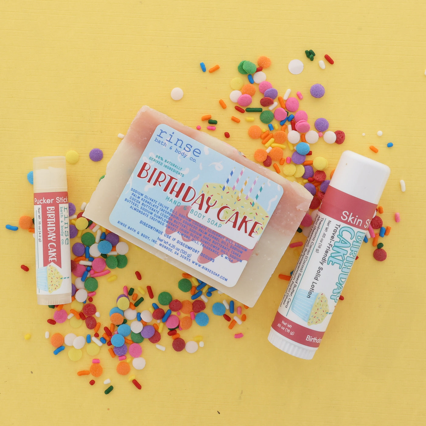 Birthday Cake themed soap and lip balm with colorful confetti on a yellow background