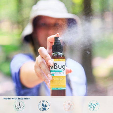 Woman spraying DeBug natural DEET-free bug repellent outdoors - 100% natural, handmade in Monroe GA